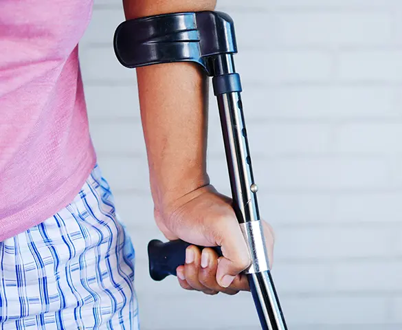 A person with crutches is holding onto the handle.